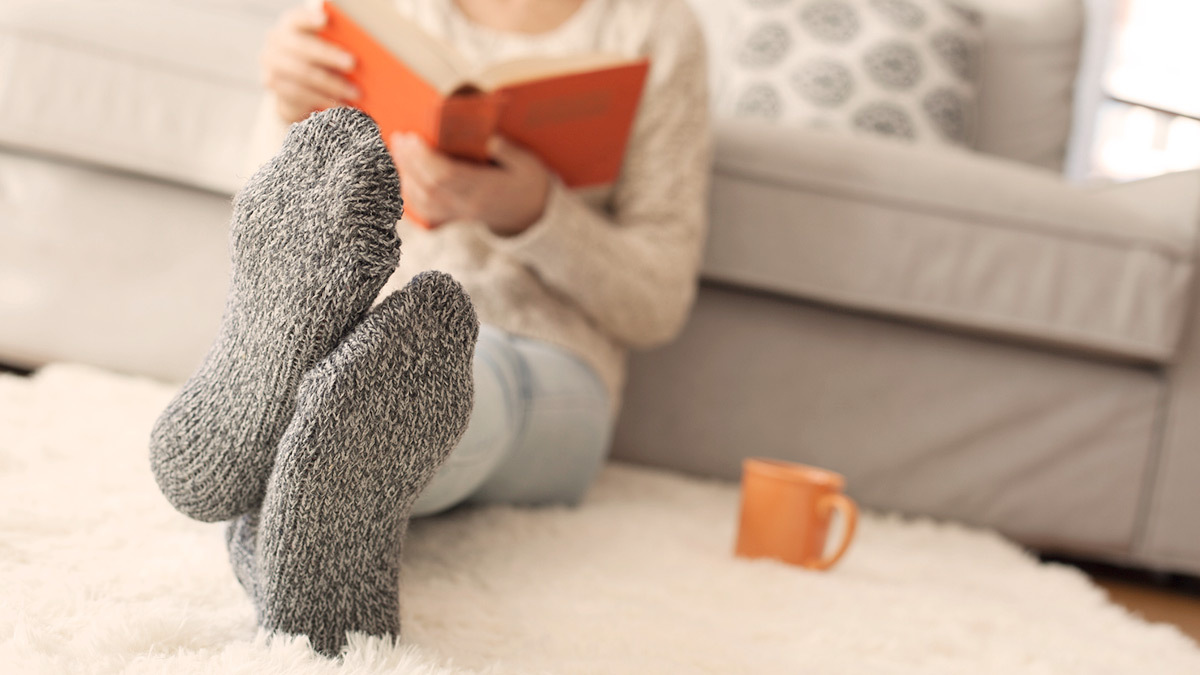 reading a book on a floor rug