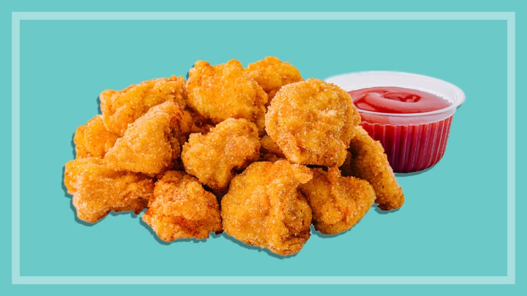 chicken nuggets with tomato sauce on a teal background