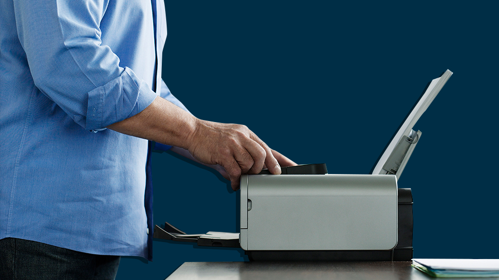 man standing at printer