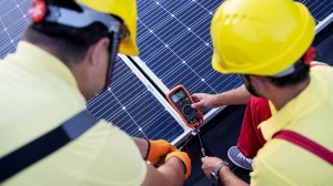 Two technicians testing a solar panel