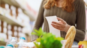 woman holding a grocery receipt