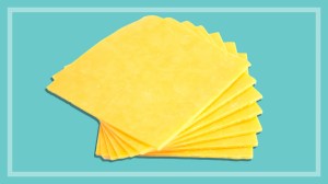 cheddar cheese slices on teal background
