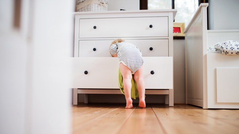 young child climbing in furniture