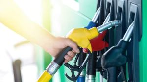 hand removing petrol pump from bowser