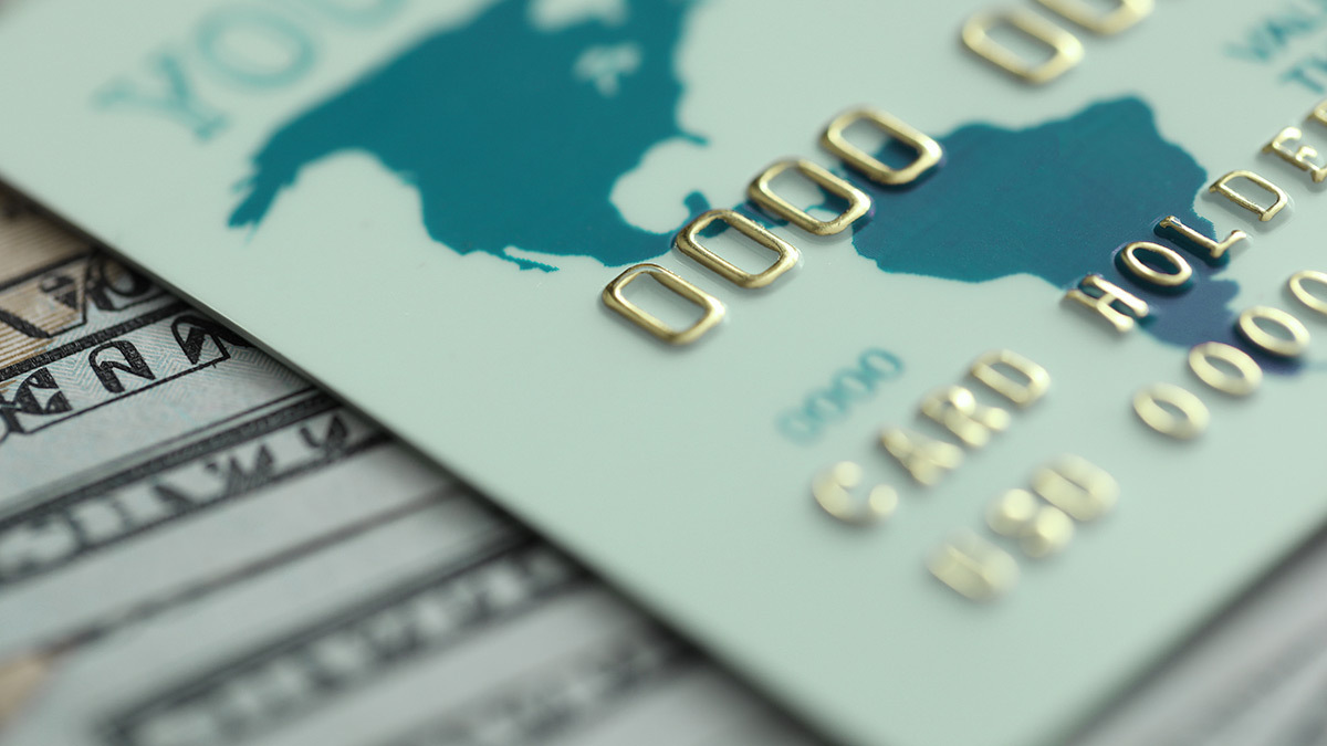 travel debit card on top of American money