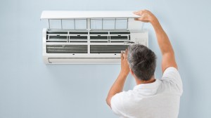 man_cleaning_air_conditioning_filter
