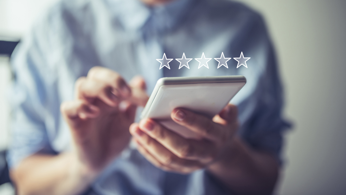 five white stars superimposed over a person holding a smartphone