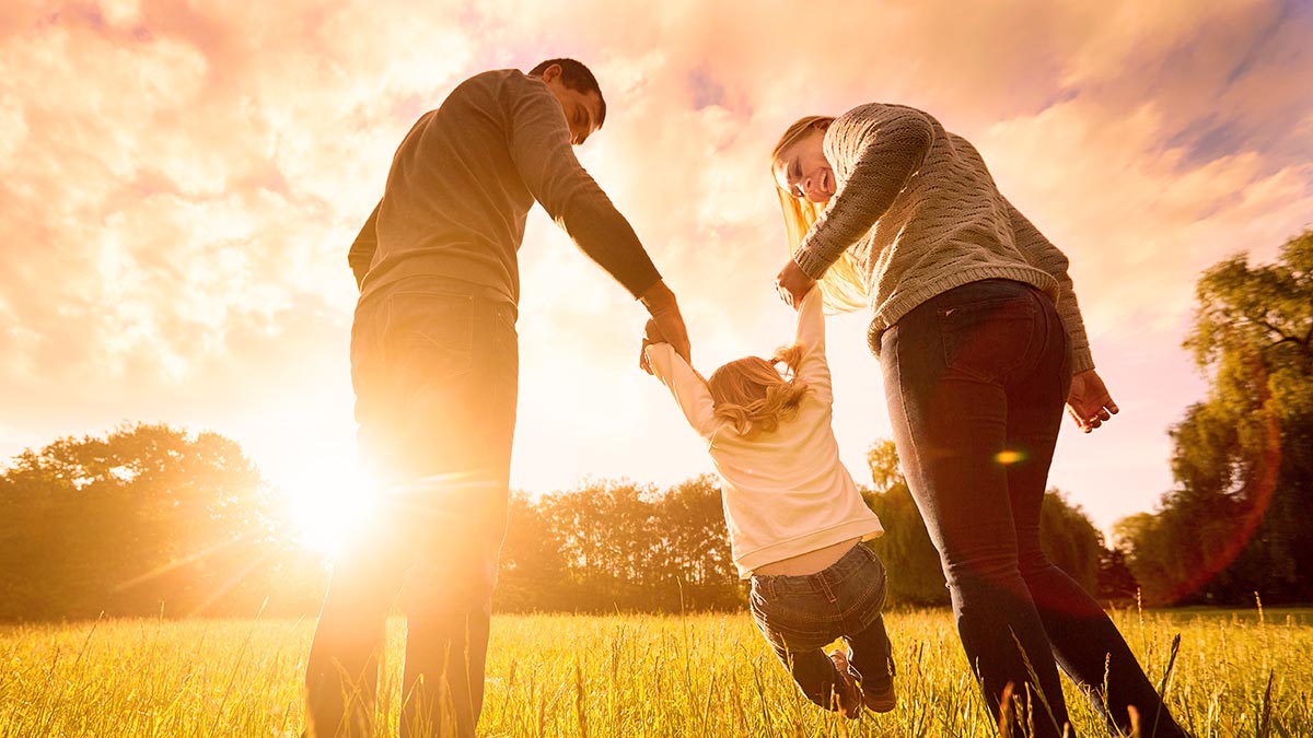 family playing in a field