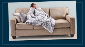woman on sofa with heated throw