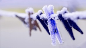 frosty pegs on a clothesline in winter