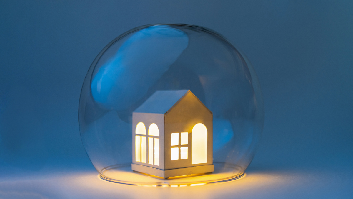 small house with the lights on surrounded by a glass bubble