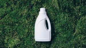 white laundry detergent bottle on green foliage